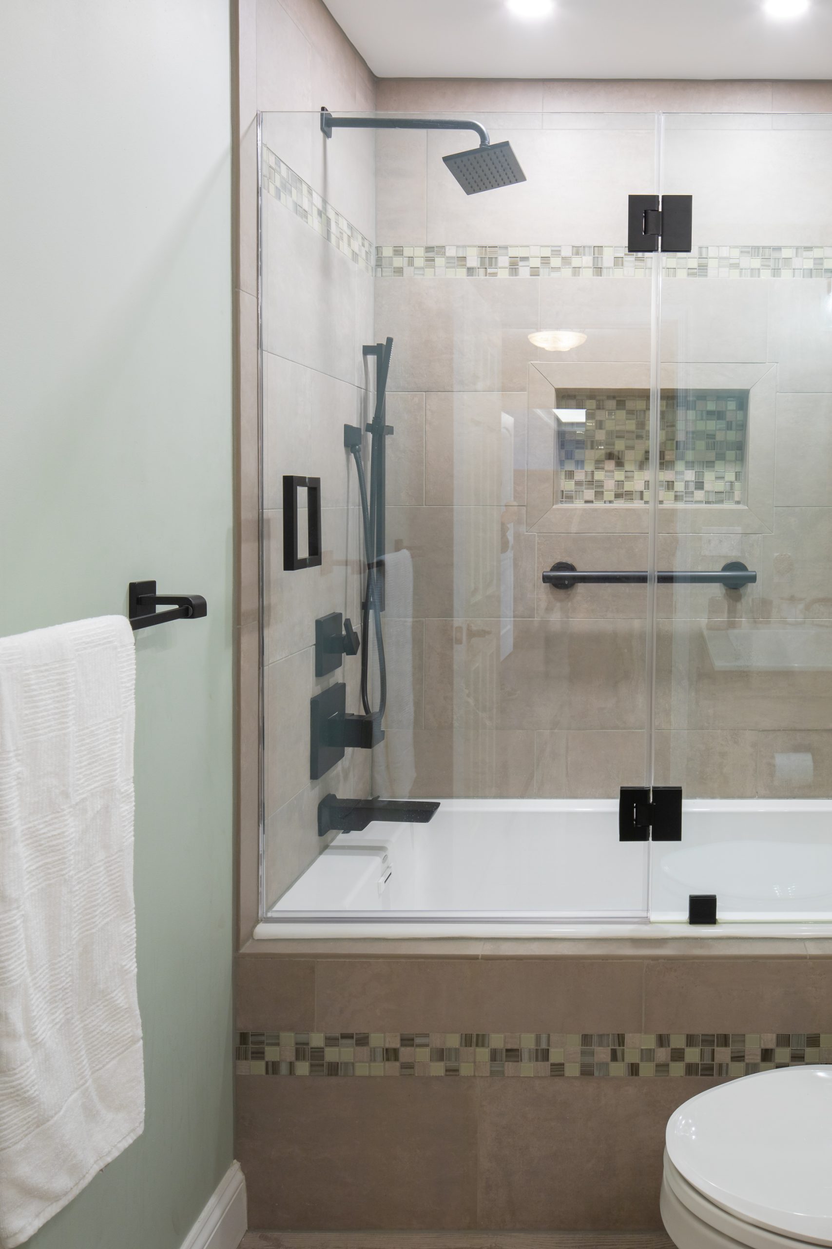 A renovated bathroom tub and shower